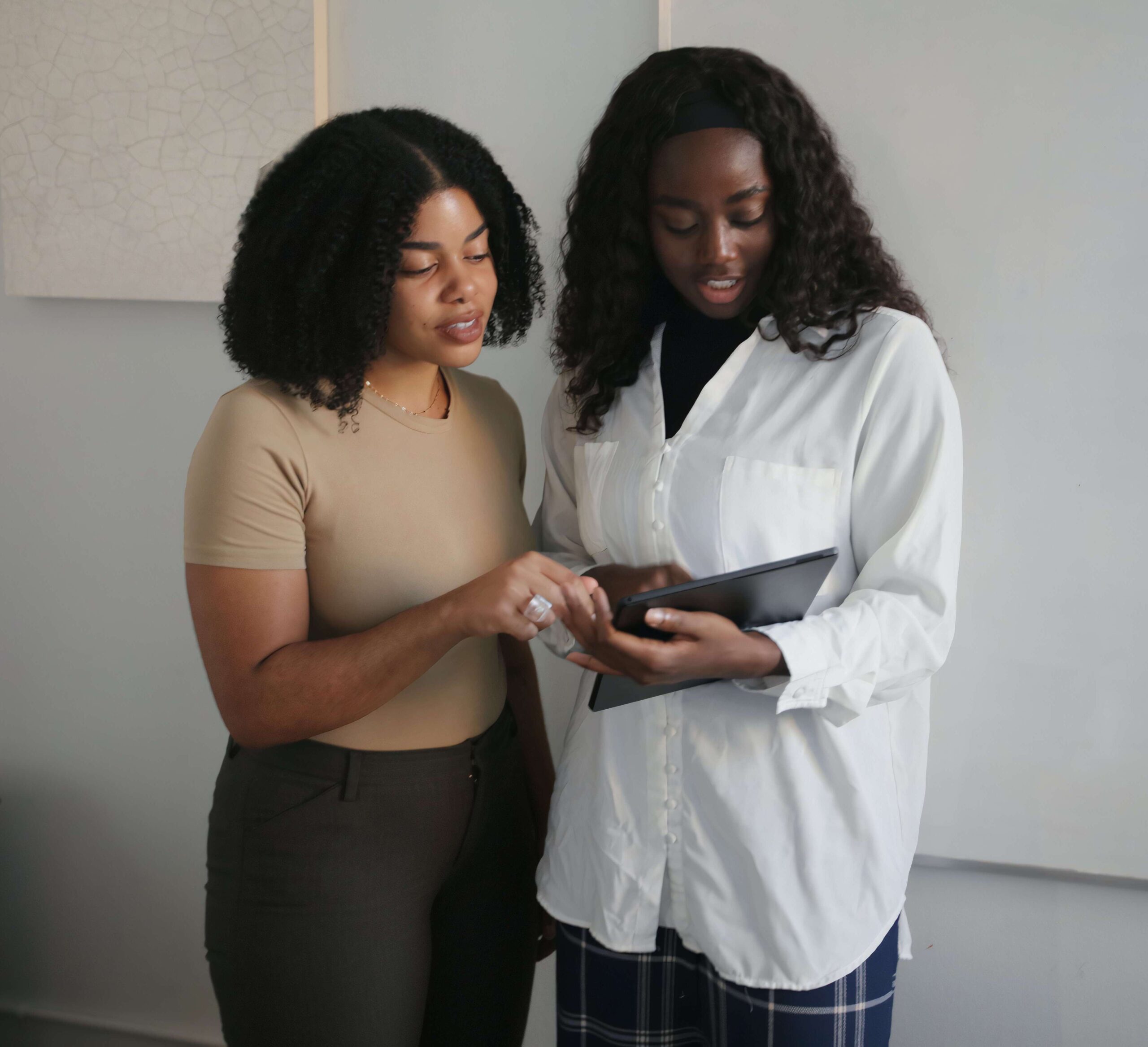 Couple of women reading on a tablet