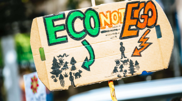 Eco not ego cardboard sign